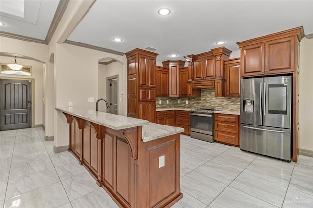 kitchen with light stone countertops, a kitchen breakfast bar, kitchen peninsula, ornamental molding, and stainless steel appliances