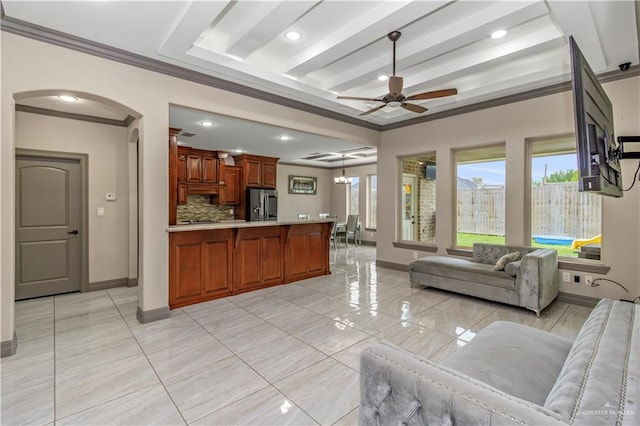 living room with beamed ceiling, ceiling fan with notable chandelier, and ornamental molding