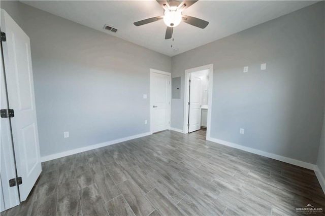 2605 Sage Dr, Weslaco, TX 78596 - unfurnished bedroom with ceiling fan, wood finished floors, visible vents, baseboards, and electric panel