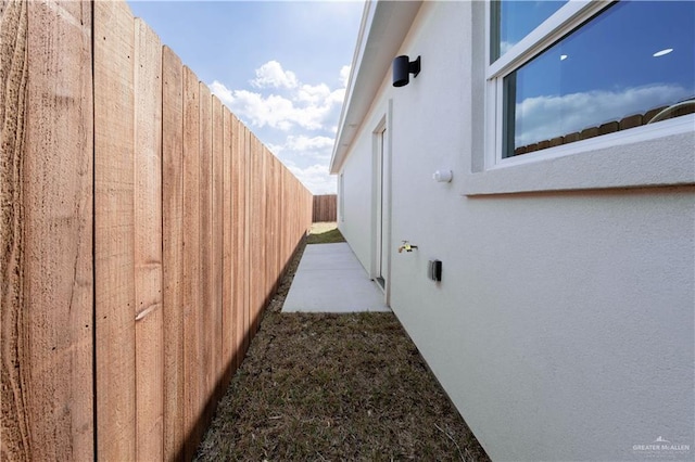 2605 Sage Dr, Weslaco, TX 78596 - view of side of home with fence and stucco siding