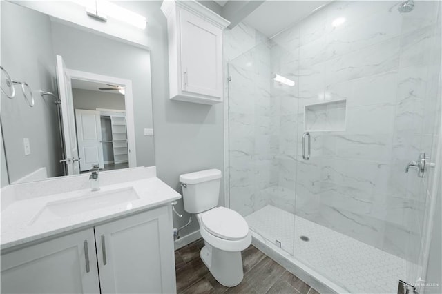 2605 Sage Dr, Weslaco, TX 78596 - full bathroom featuring a marble finish shower, baseboards, toilet, wood finished floors, and vanity