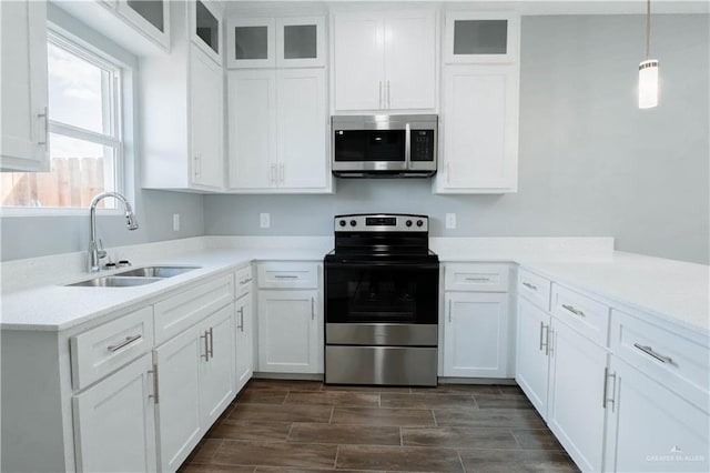 2605 Sage Dr, Weslaco, TX 78596 - kitchen featuring stainless steel appliances, light countertops, white cabinets, and a sink