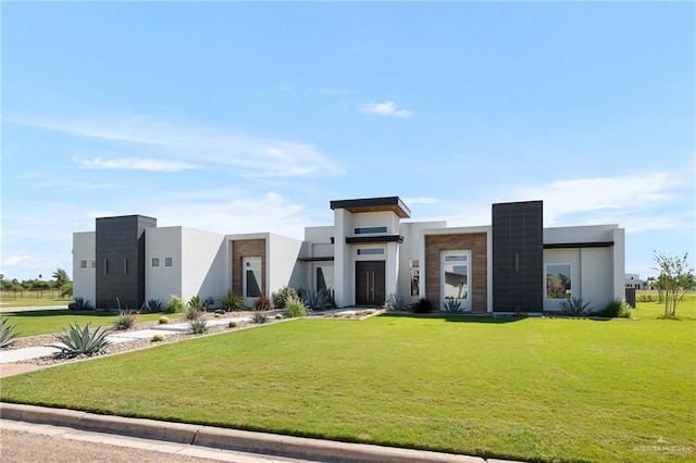 modern home featuring a front lawn