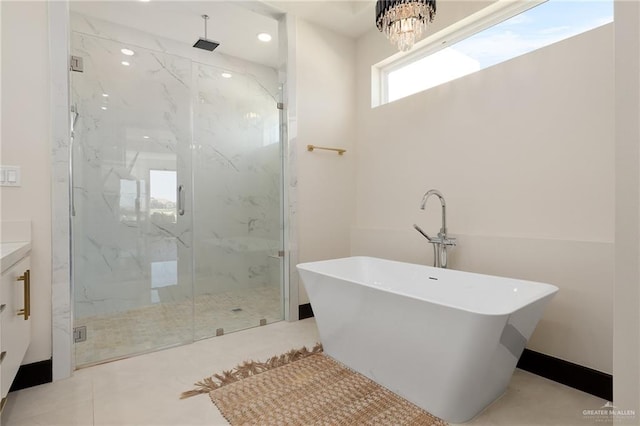 bathroom with a chandelier, vanity, and plus walk in shower