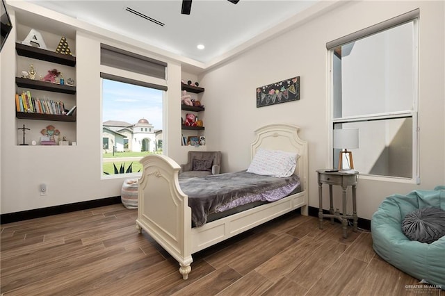 bedroom featuring ceiling fan and dark hardwood / wood-style flooring