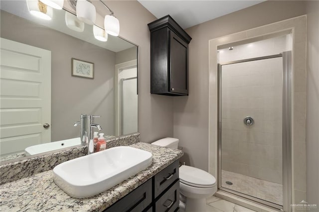 bathroom with vanity, toilet, and an enclosed shower