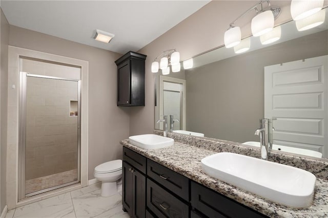 bathroom featuring vanity, toilet, and a shower with shower door