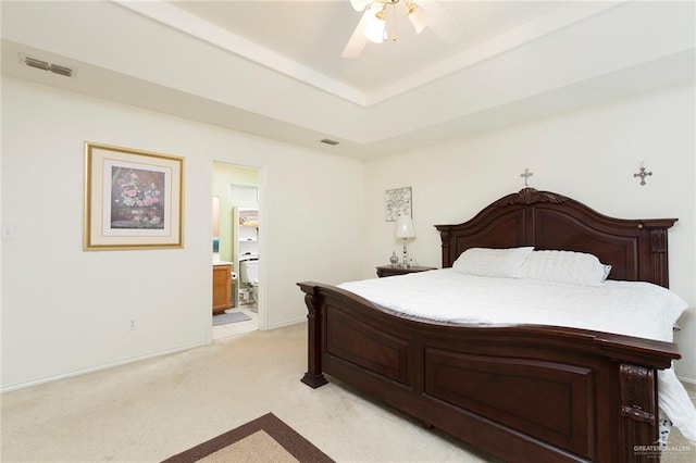 bedroom featuring connected bathroom, ceiling fan, and light carpet