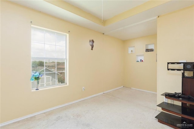 unfurnished room featuring light carpet