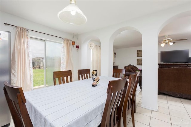 dining space with ceiling fan and light tile patterned flooring