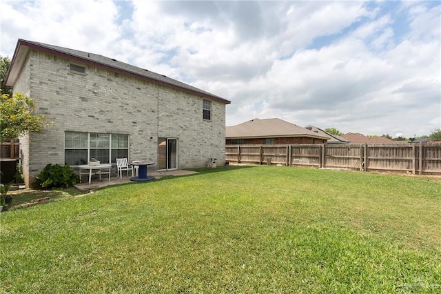 rear view of property featuring a yard