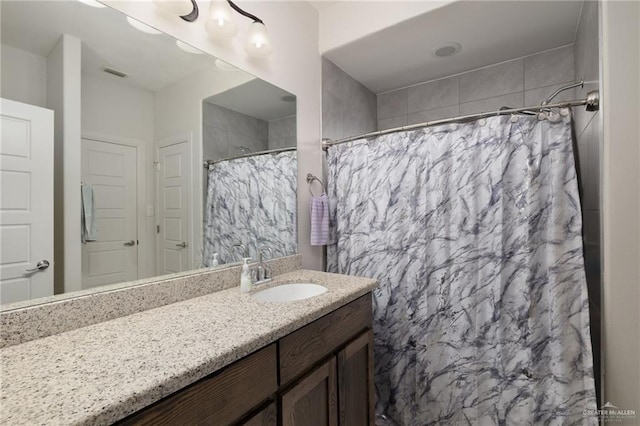 bathroom featuring visible vents, vanity, and a shower with shower curtain