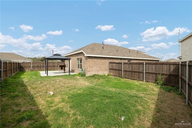 view of yard featuring a gazebo, a patio area, and a fenced backyard