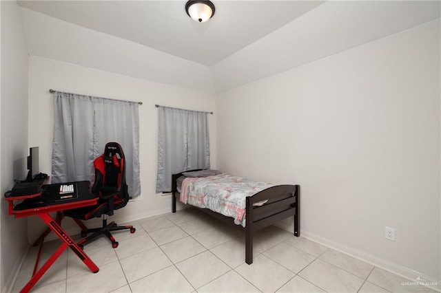 bedroom featuring light tile patterned flooring and baseboards