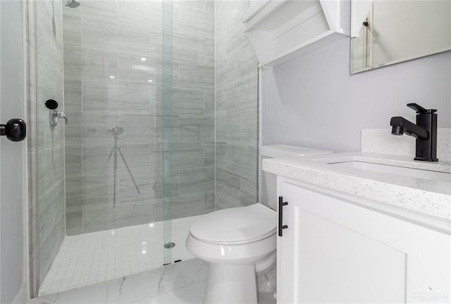 bathroom with vanity, toilet, and an enclosed shower