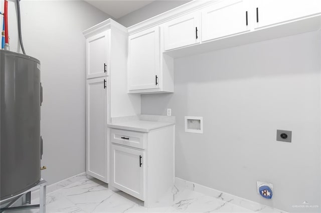 laundry room featuring electric water heater, hookup for a washing machine, cabinets, and hookup for an electric dryer