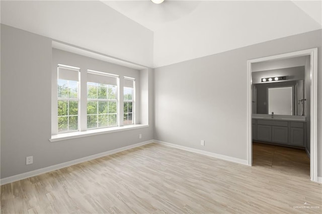 spare room with light wood-type flooring and sink