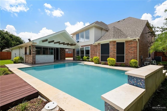 back of property with a pool side deck