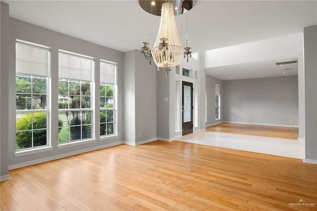 unfurnished room featuring hardwood / wood-style flooring and plenty of natural light