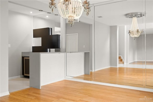 kitchen featuring hardwood / wood-style floors and a chandelier