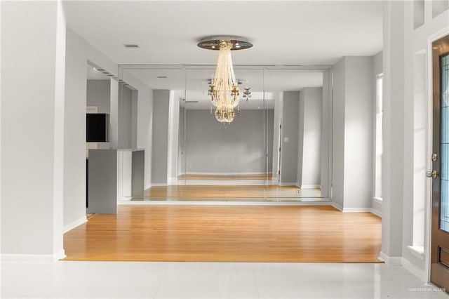 interior space with hardwood / wood-style floors and a notable chandelier