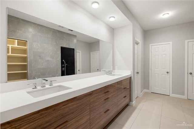 bathroom with tile patterned flooring, vanity, tile walls, and walk in shower