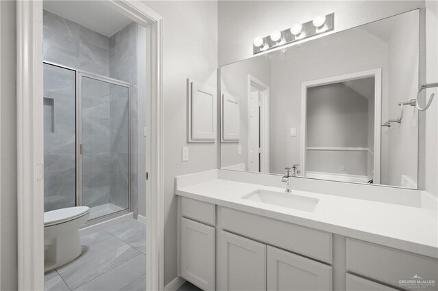 bathroom featuring tile patterned flooring, vanity, toilet, and walk in shower