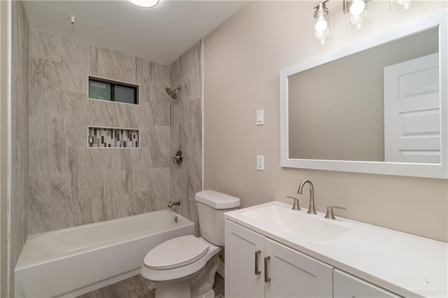 full bathroom featuring hardwood / wood-style flooring, toilet, vanity, and tiled shower / bath