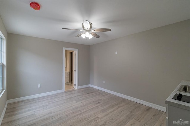 unfurnished room featuring ceiling fan and light hardwood / wood-style floors