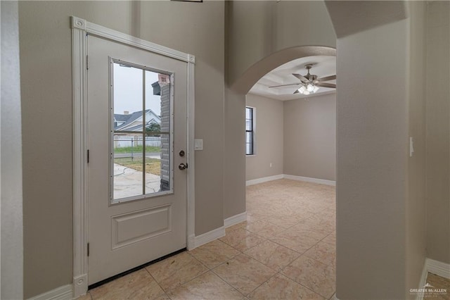 foyer with ceiling fan and light tile patterned flooring