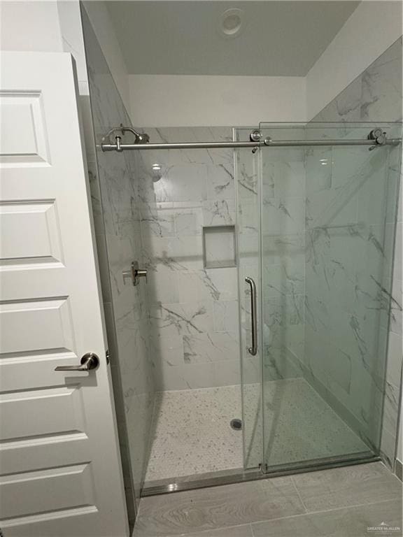 bathroom with a shower with shower door