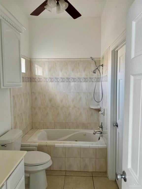 full bathroom featuring vanity, ceiling fan, tile patterned flooring, toilet, and tiled shower / bath