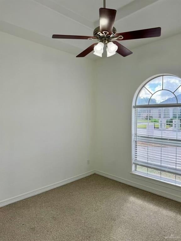 empty room featuring carpet flooring and ceiling fan