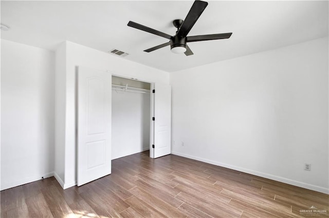 unfurnished bedroom with a closet, ceiling fan, and hardwood / wood-style floors