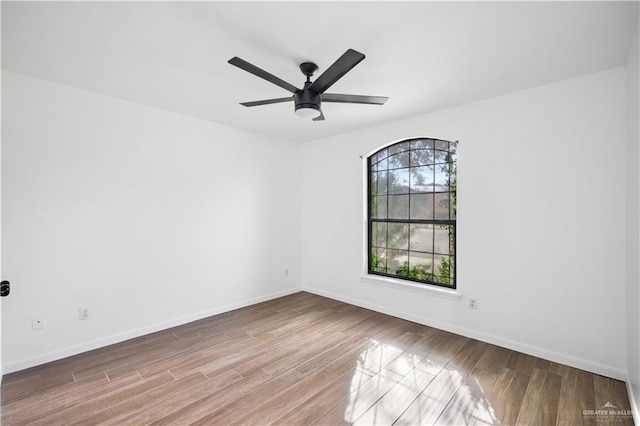 spare room with ceiling fan and light wood-type flooring