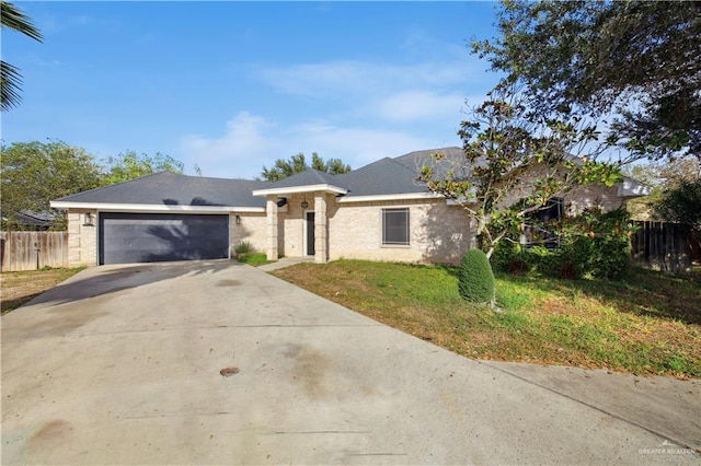 view of front of property featuring a front lawn and a garage