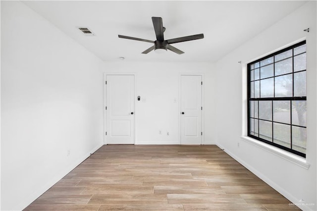 spare room featuring ceiling fan and light hardwood / wood-style flooring