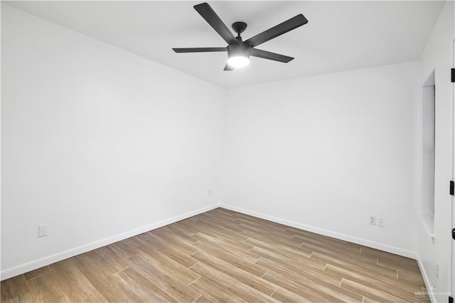 spare room with ceiling fan and light wood-type flooring