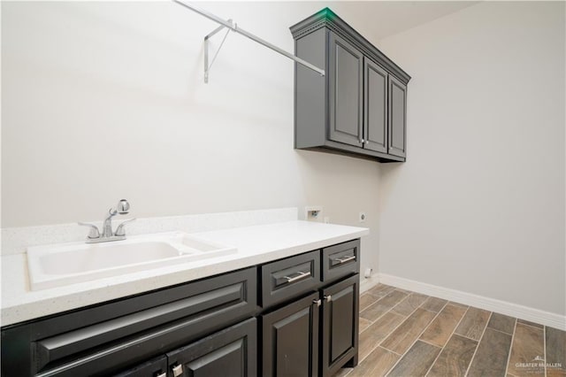13809 N 37th St, Mcallen, TX 78504 - laundry room with cabinet space, hookup for an electric dryer, wood finished floors, and baseboards