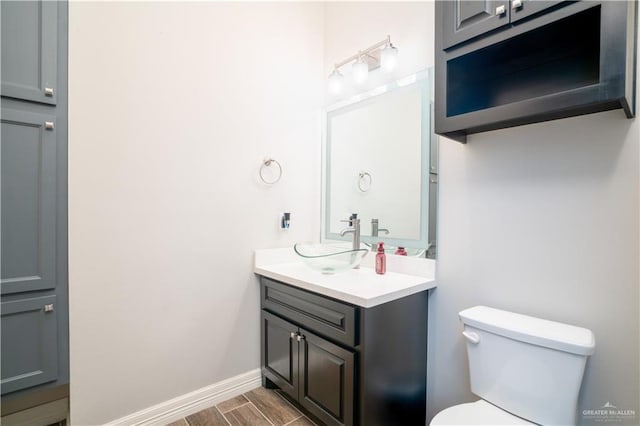 13809 N 37th St, Mcallen, TX 78504 - half bath featuring toilet, vanity, baseboards, and wood finished floors