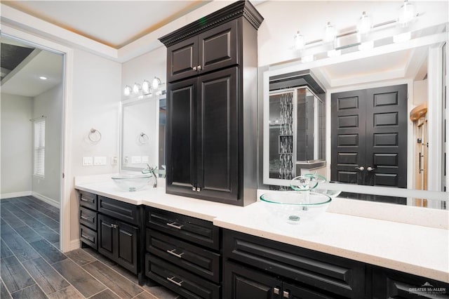 13809 N 37th St, Mcallen, TX 78504 - bathroom with double vanity, baseboards, and wood finished floors