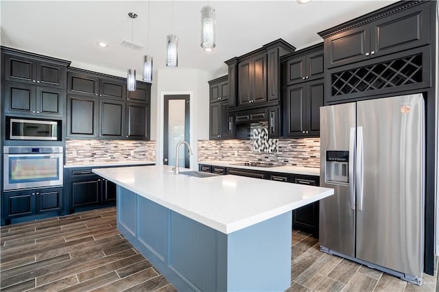13809 N 37th St, Mcallen, TX 78504 - kitchen with appliances with stainless steel finishes, a sink, wood tiled floors, light countertops, and recessed lighting