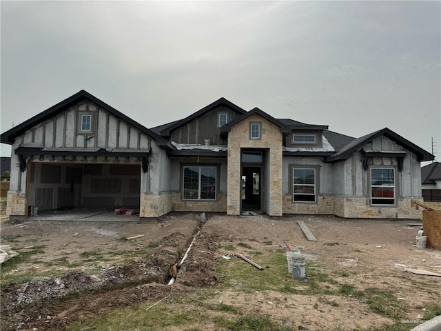 3009 Timberwood Ave, Mission, TX 78574 - unfinished property with board and batten siding, stone siding, and a garage