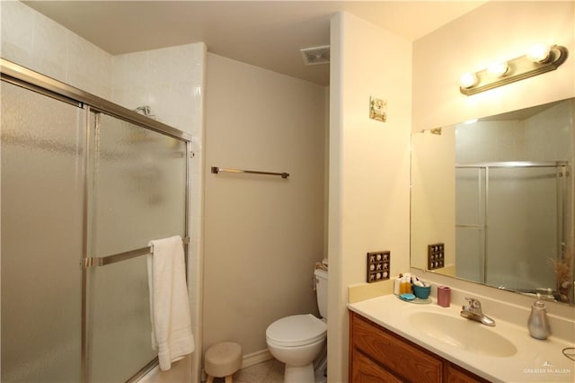 bathroom featuring vanity, toilet, and a shower with shower door