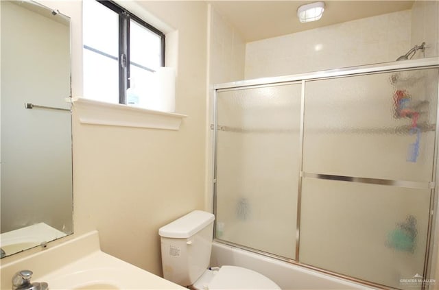 full bathroom with vanity, toilet, and enclosed tub / shower combo