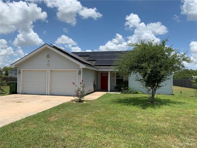 14022 Whitewing Ln, Lyford, TX 78569 - ranch-style house featuring solar panels, a garage, and driveway
