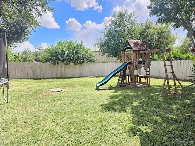 view of jungle gym featuring a yard and a trampoline