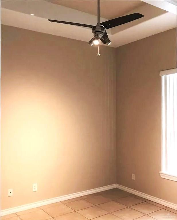 spare room with light tile patterned floors and ceiling fan