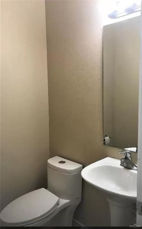 bathroom with sink and toilet