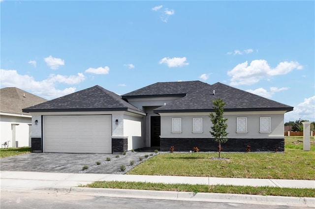 view of front of home featuring central AC unit, a garage, and a front lawn